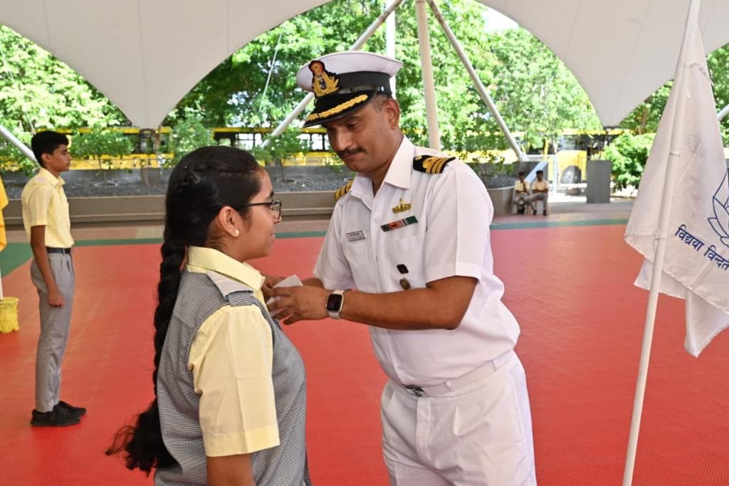 A naval officer felicitates a Lakshmi School cadet